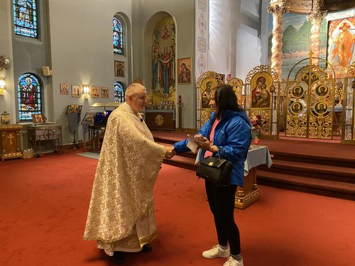 Handshake during the GCU check presentation inside St. John the Baptist church